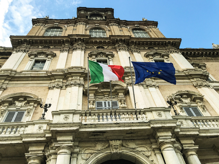 Italian and european flags on the facade of government palace vawing in the windのeditorial素材