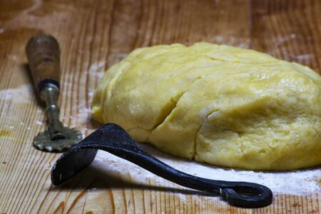 homemade and handmade ball of dough with flour and cooking instrumentsの写真素材