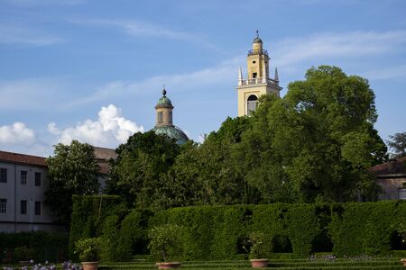 Scenic wiev ot italian historical gardens with baroque bells tower. Tourism conceptの写真素材