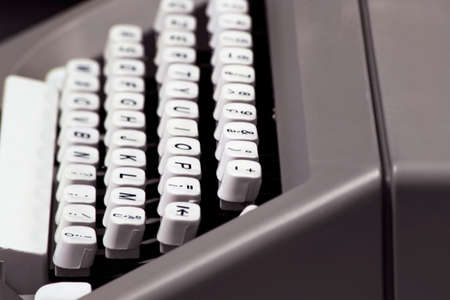 keyboard of an old manual typewriter: white keys and black lettersの写真素材