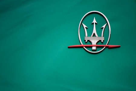 09/10/20 - Modena, Italy - Maserati logo on a green surface. concept lor luxury lifestyle, italian designのeditorial素材