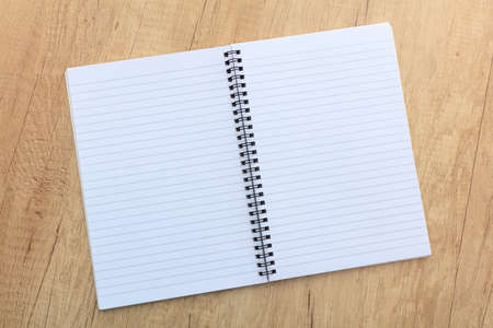 open notepad on a wooden surfaceの写真素材