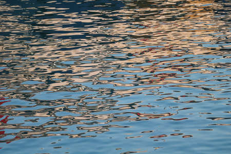Boat reflections on sea waterの写真素材