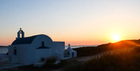 Small church by the sea at sunsetの写真素材