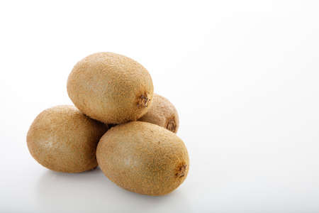 Kiwis stacked on white backgroundの写真素材