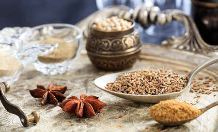 Cumin seeds and powder in spoonsの写真素材