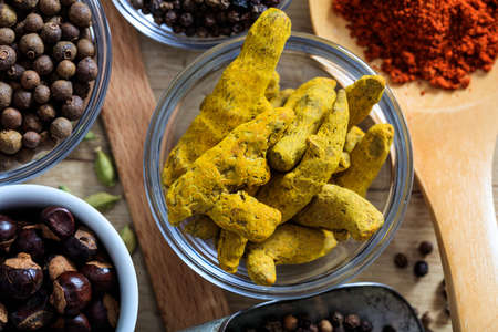 Turmeric and other spices on a wooden surfaceの写真素材