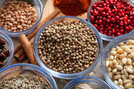 Coriander and other spices on a wooden surfaceの写真素材