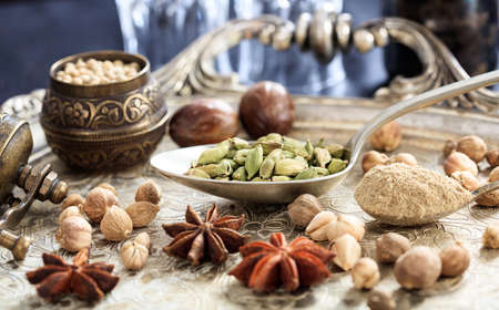 Cardamom seeds and powder in spoons
