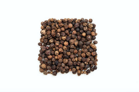 Black pepper seeds on white backgroundの写真素材