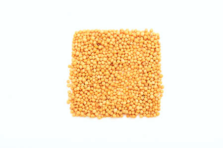 Mustard seeds in a square shape on a white backgroundの写真素材