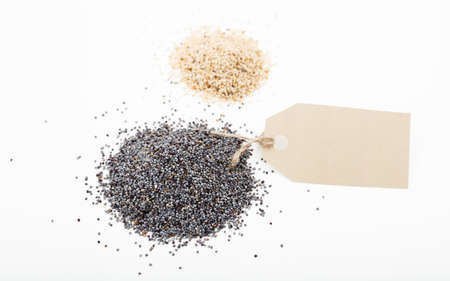 White and black poppy seeds on white backgroundの写真素材