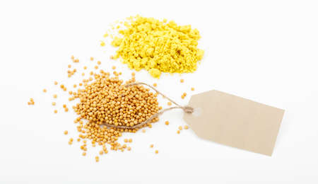 Mustard seeds and powder with label on white backgroundの写真素材
