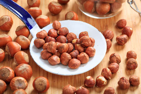 Hazelnuts and an old ladle on a table