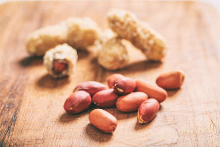 Salted peanuts on a wooden tableの写真素材