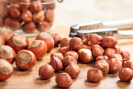 Hazelnuts and a nutcracker on a wooden table