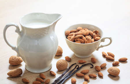 Vegan milk from almonds on a wooden surfaceの写真素材
