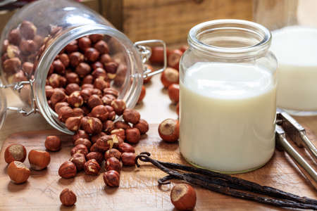 Vegan milk from hazelnuts on a wooden surfaceの写真素材