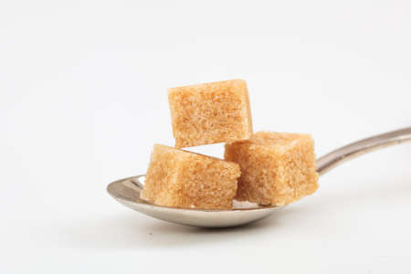 Brown sugar cubes on white backgroundの写真素材