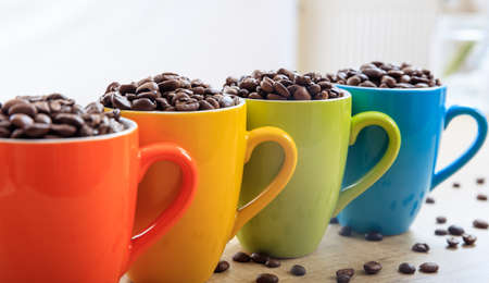 Colorful cups full of coffee beansの写真素材