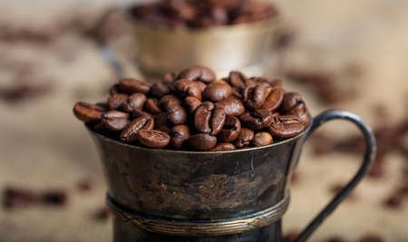 Coffee beans and old cups on a burlapの写真素材
