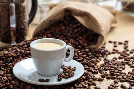 Coffee beans and a cup of coffeeの写真素材