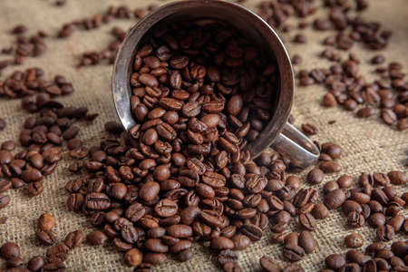 Coffee beans and a metal old ladleの写真素材