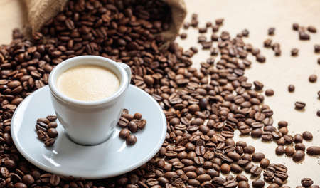 Coffee beans and a cup of coffeeの写真素材