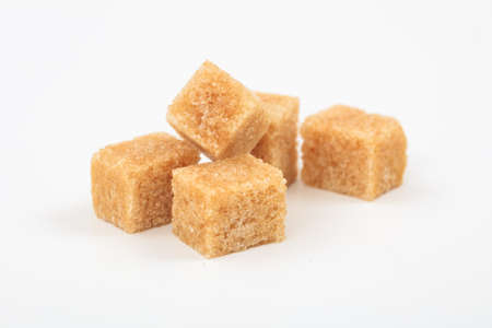 Brown sugar cubes on white backgroundの写真素材