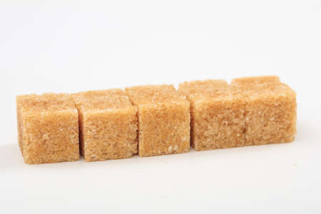 Brown sugar cubes on white backgroundの写真素材