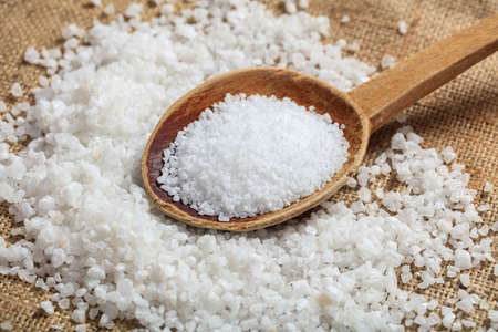 White salt crystals in a wooden spoonの写真素材