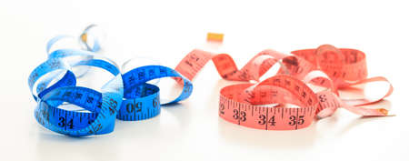 Two measuring tapes on white backgroundの写真素材