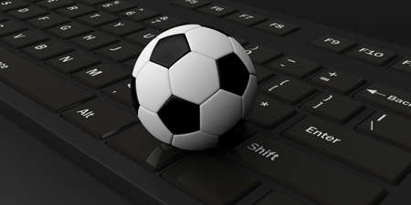 3d rendering soccer ball on a black keyboardの写真素材