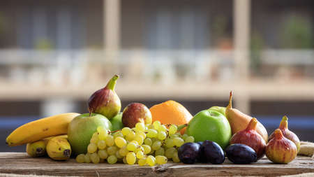Variety of fresh fruits on a wooden tableの写真素材