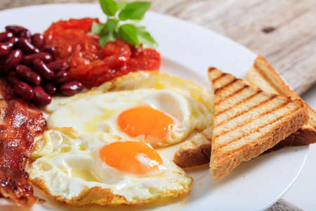 Fried eggs, bacon and kidney beansの写真素材
