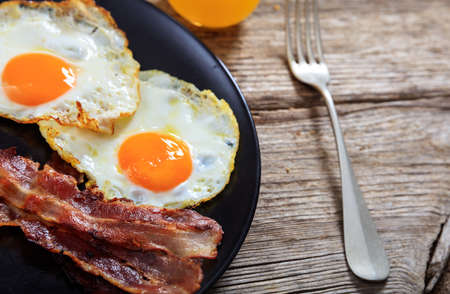 Fried eggs and bacon plateの写真素材