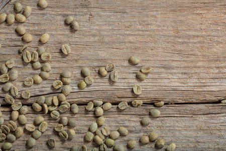 Green coffee beans on wooden backgroundの写真素材