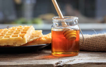 Waffles and honey on a table