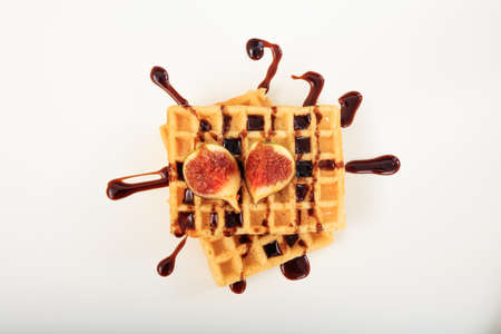 Waffle with syrup and figs on white backgroundの写真素材