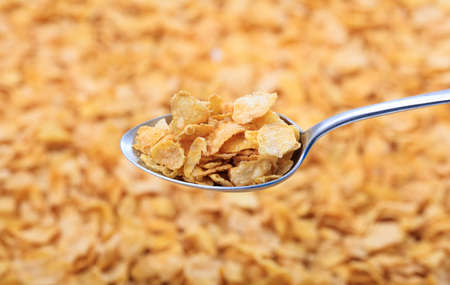 Old spoon on corn flakes backgroundの写真素材