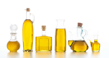 Set of glass bottles with olive oil on white backgroundの写真素材