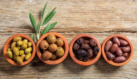 Variety of olives in wooden bowlsの写真素材