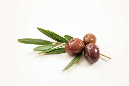 Olives and olive branch isolated on white backgroundの写真素材