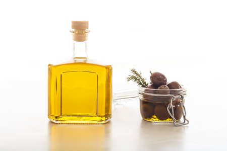 Bottle of olive oil and olives on white backgroundの写真素材