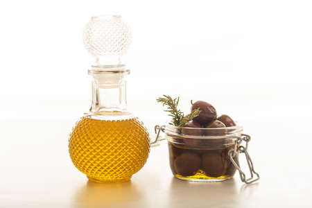 Bottle of olive oil and olives on white backgroundの写真素材
