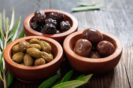 Variety of olives in wooden bowlsの写真素材
