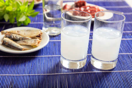 Glasses of ouzo and appetizersの写真素材
