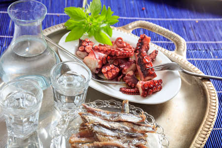 Glasses of ouzo and appetizersの写真素材