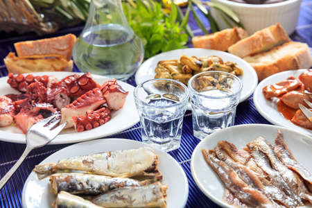 Glasses of ouzo and appetizersの写真素材