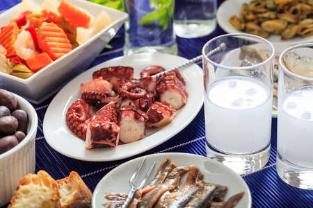 Glasses of ouzo and appetizersの写真素材